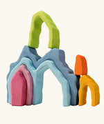 Grimm's cave arch stacker pastel wooden toy used in a stack.