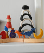 Grimm's celebration ring pieces in a line displaying various decorative figure including a fox, bat, moon owl and dwarf