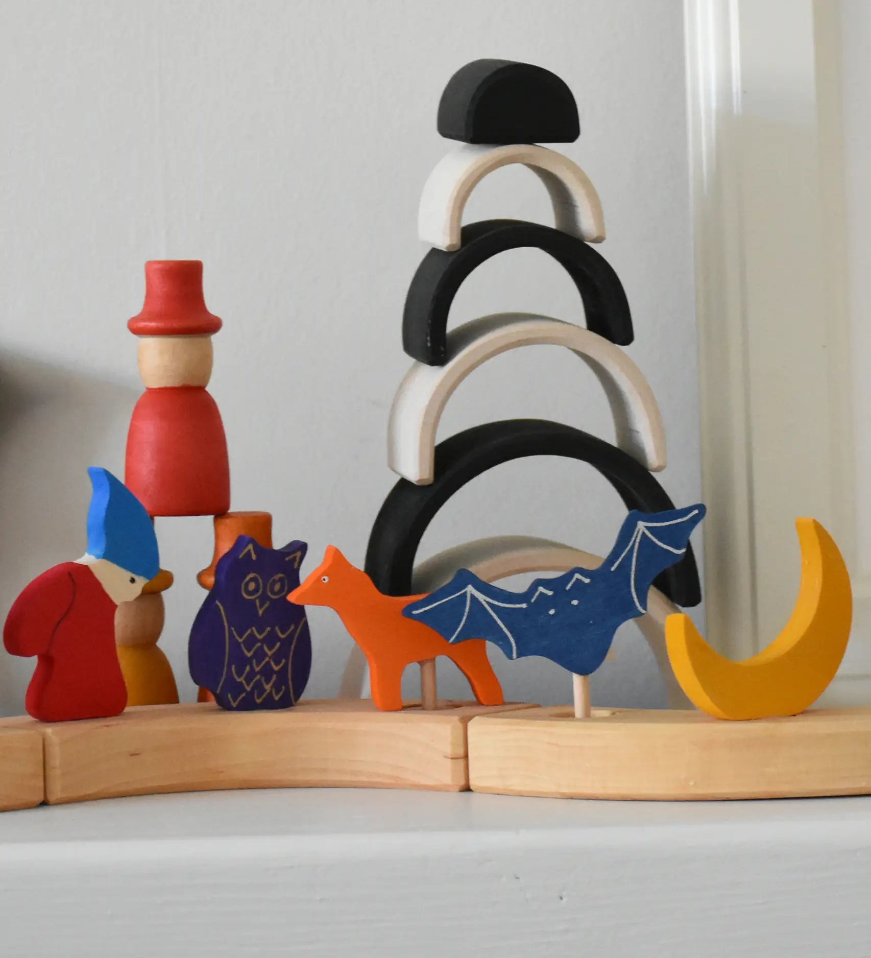 Grimm's celebration ring pieces in a line displaying various decorative figure including a fox, bat, moon owl and dwarf