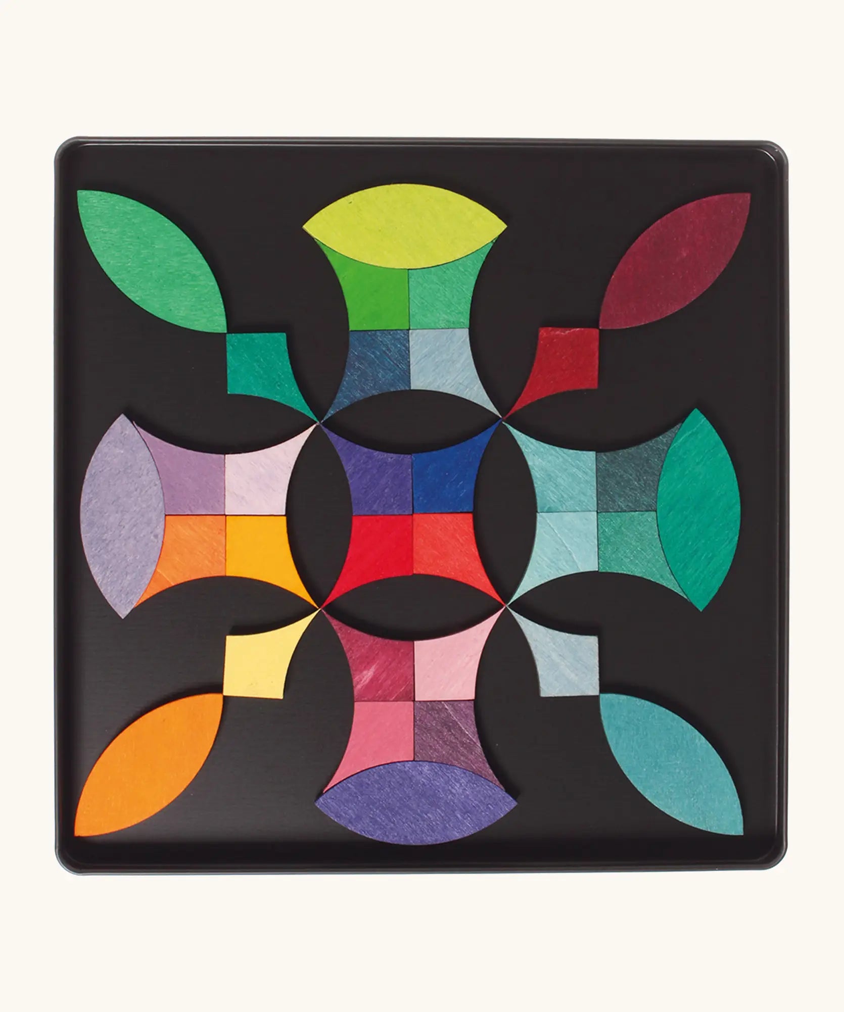 A abstract shape using the Grimm's bright wooden circular magnetic pieces displayed in a tin 