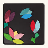 A flower and butterfly using the Grimm's bright wooden circular magnetic pieces displayed in a tin 