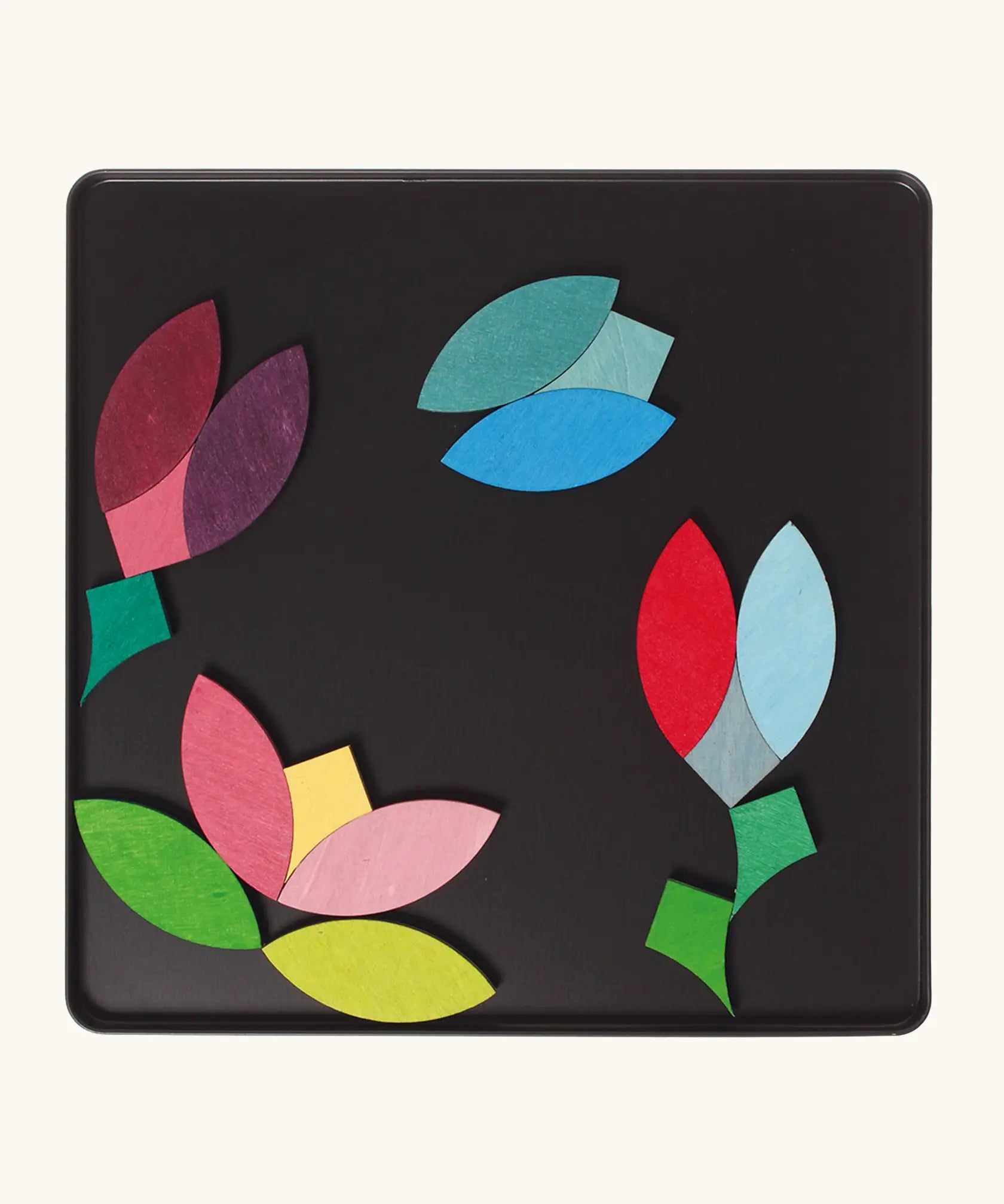 A flower and butterfly using the Grimm's bright wooden circular magnetic pieces displayed in a tin 