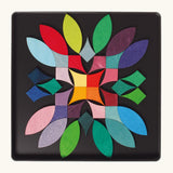 A abstract flower using the Grimm's bright wooden circular magnetic pieces displayed in a tin 