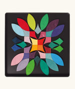 A abstract flower using the Grimm's bright wooden circular magnetic pieces displayed in a tin 