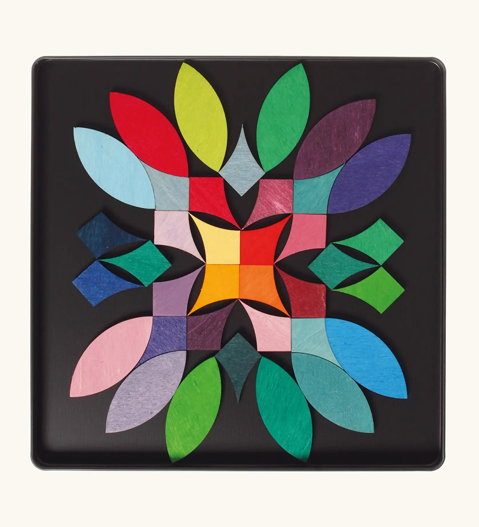 A abstract flower using the Grimm's bright wooden circular magnetic pieces displayed in a tin 