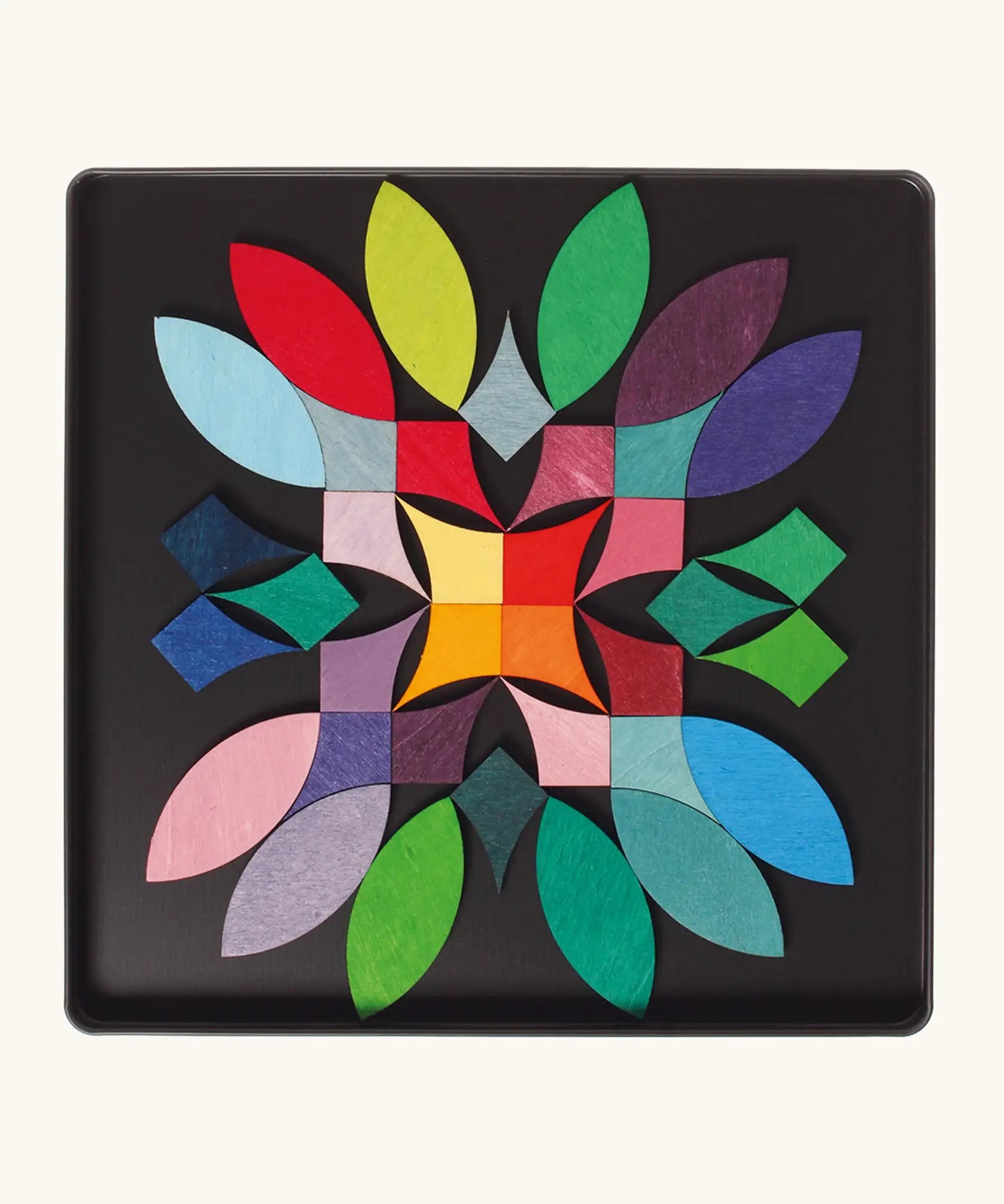 A abstract flower using the Grimm's bright wooden circular magnetic pieces displayed in a tin 