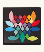 Loose Grimm's bright wooden circular magnetic pieces displayed in a tin 