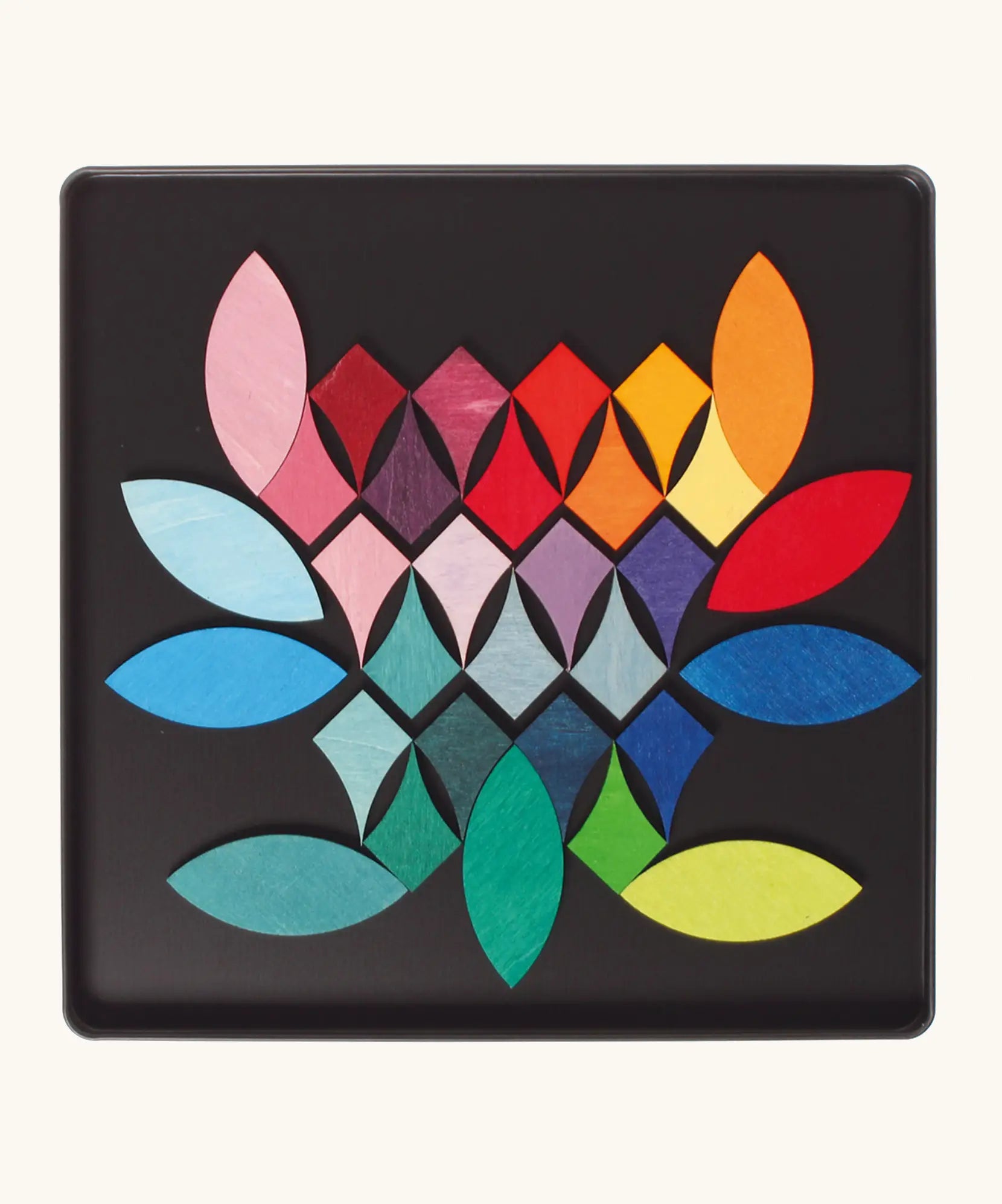 Loose Grimm's bright wooden circular magnetic pieces displayed in a tin 