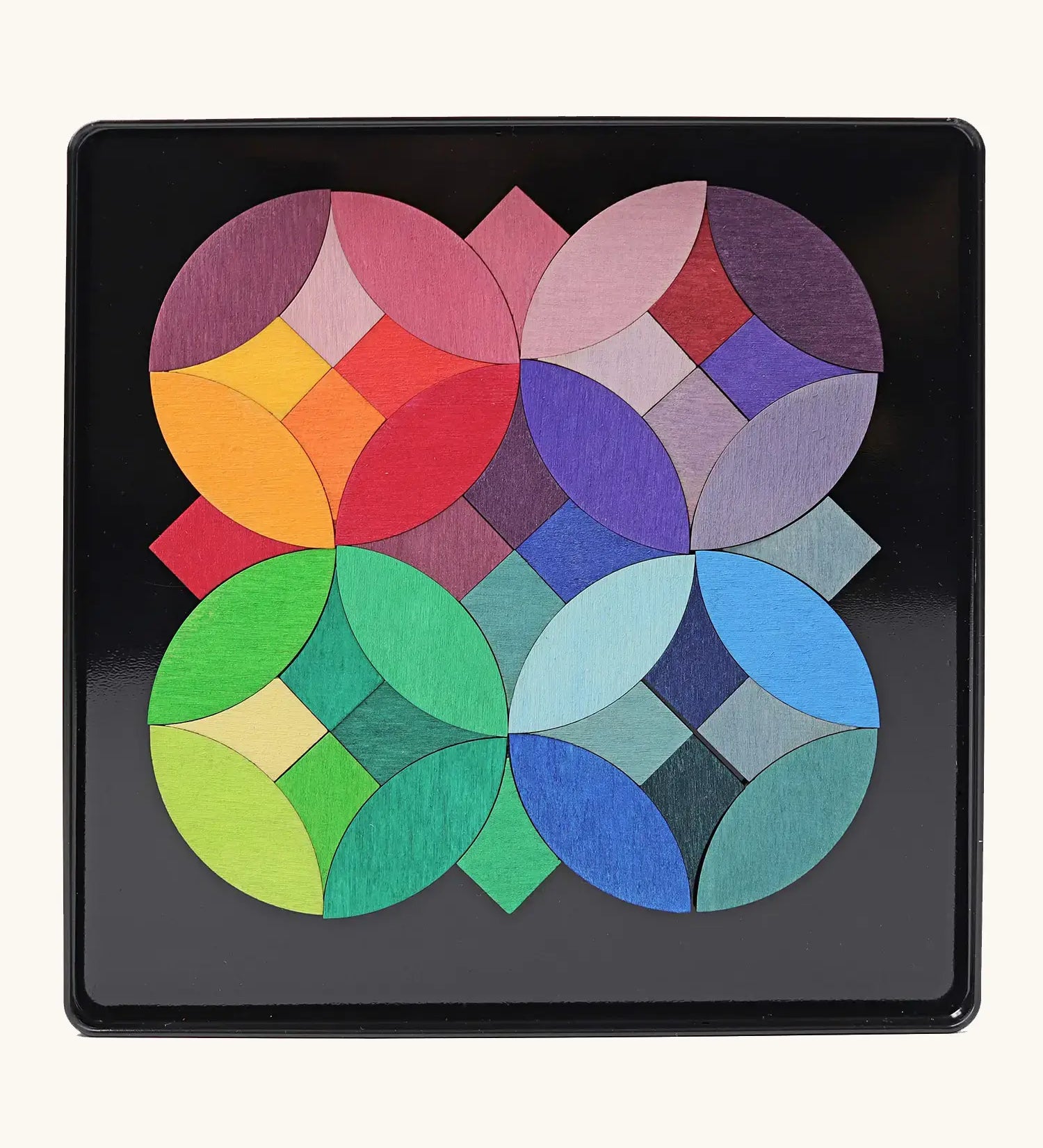 Grimms circles magnet puzzle set. Includes 40 plywood magnetic pieces in bright colours and a storage tin