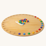 Grimm's Circular Disc & 35 Marbles on a plain background. 