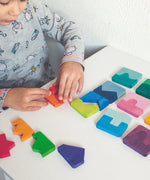 Grimm's concave finds convex wooden toy puzzle set played with by a child.