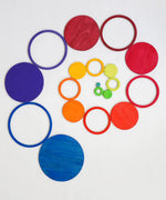 A swirl pattern made from the rings and disks of the Grimms concentric set in counting by colours palette