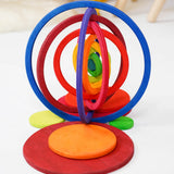 The wooden rings from the Grimms concentric set made into a 3D structure standing on the disks in counting by colour palette