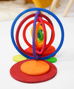 The wooden rings from the Grimms concentric set made into a 3D structure standing on the disks in counting by colour palette