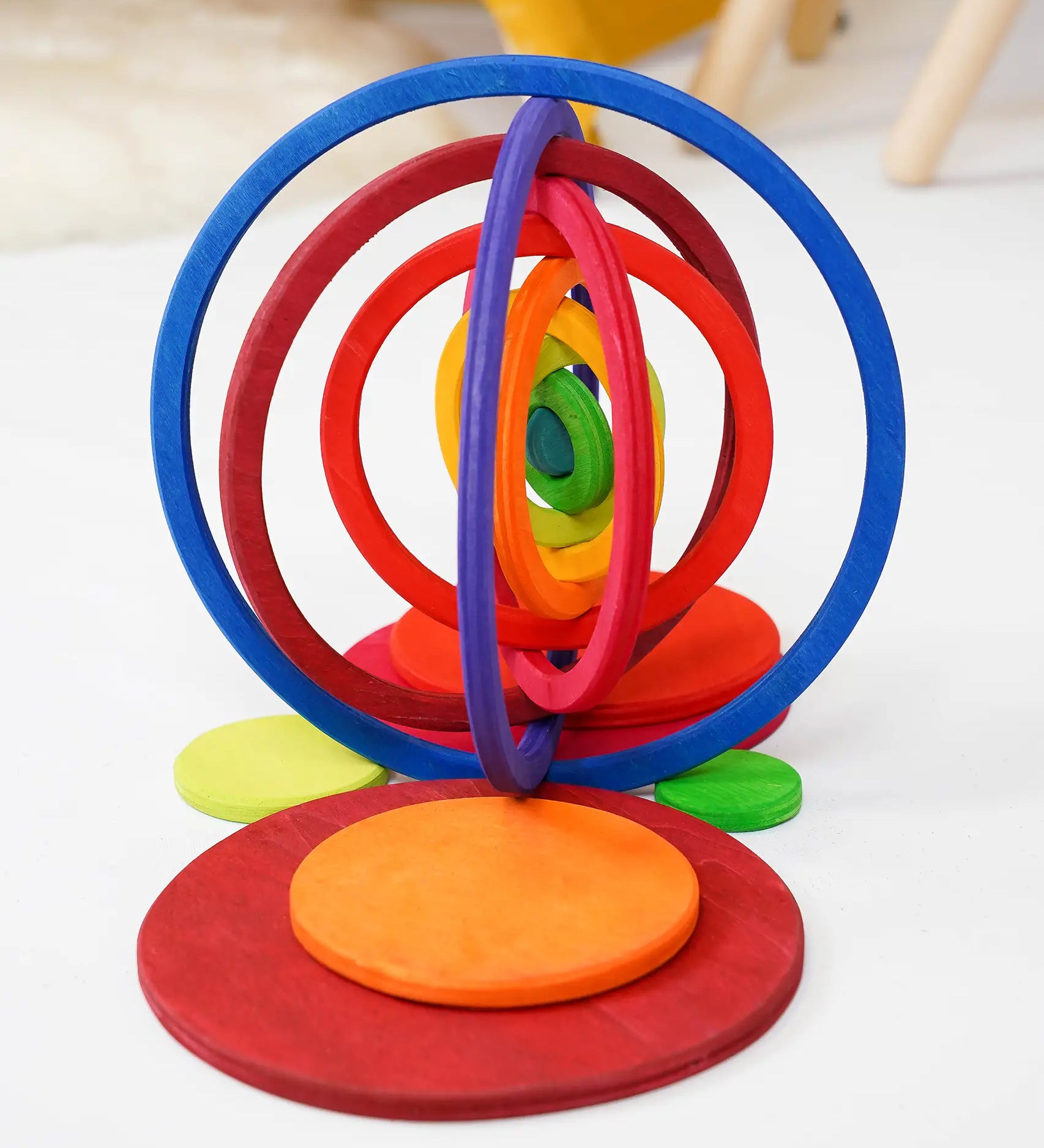 The wooden rings from the Grimms concentric set made into a 3D structure standing on the disks in counting by colour palette