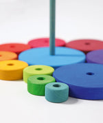 Loose disk pieces from the Grimms conical tower showing the hand cut detail and Grimm’s World of Numbers palette