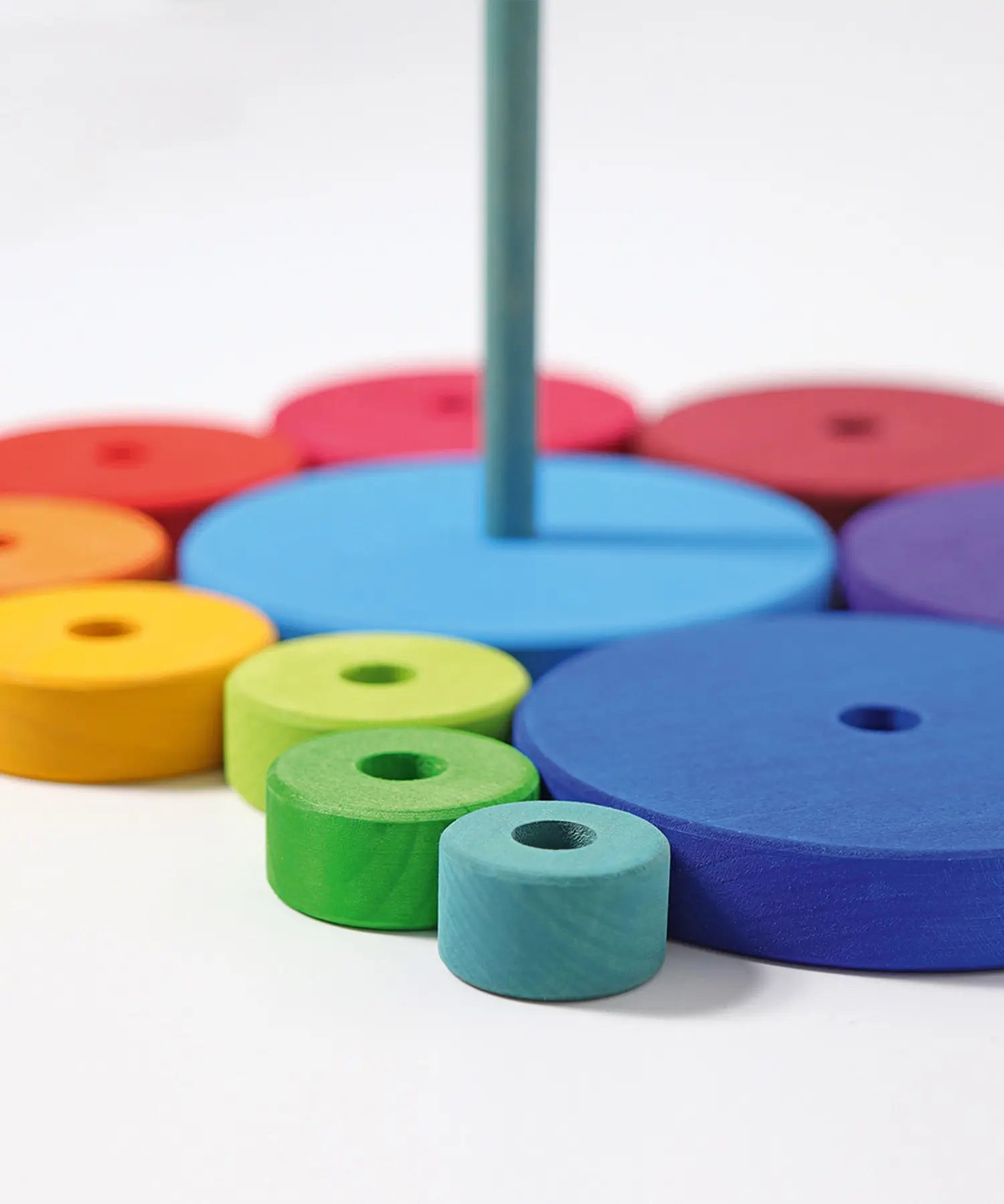 Loose disk pieces from the Grimms conical tower showing the hand cut detail and Grimm’s World of Numbers palette