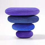 Inverted stack using 4 handcrafted Grimms wooden tactile pebbles in shades of blue and purple