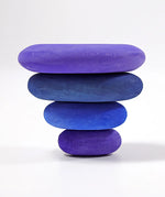 Inverted stack using 4 handcrafted Grimms wooden tactile pebbles in shades of blue and purple