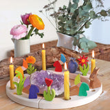 Grimm's celebration ring decoarted with dwarf and flowers decorative figures and candles.