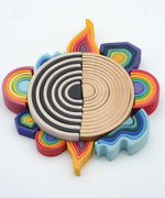 Grimms mini and large elements block laid in a circle with 6 piece rainbow with a larger 12 piece rainbow sets in the middle