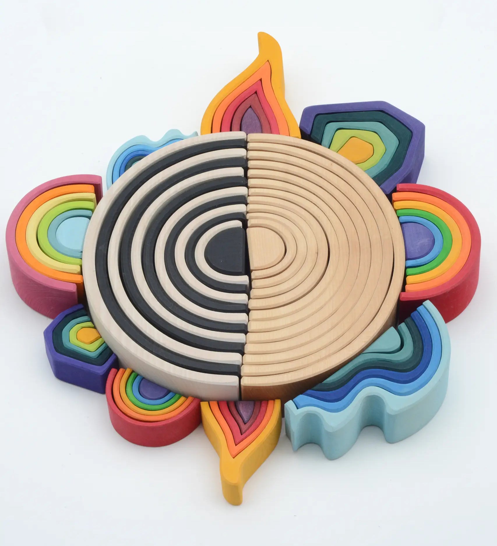 Grimms mini and large elements block laid in a circle with 6 piece rainbow with a larger 12 piece rainbow sets in the middle