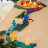 A festive display showing a Grimm's handcrafted wooden celebration spiral pieces and a angel decoration figure