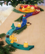 A festive display showing a Grimm's handcrafted wooden celebration spiral pieces and a angel decoration figure
