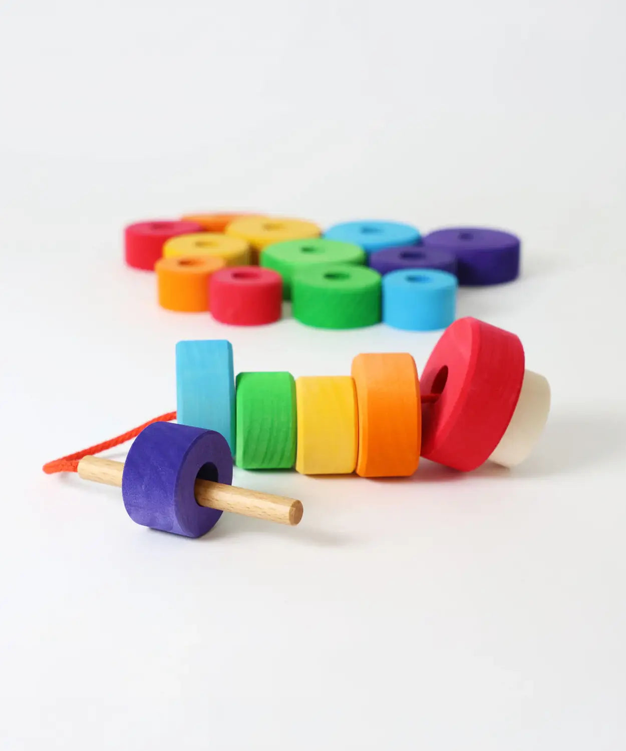 Grimms bright and chunky handcrafted wooden with threading needle and string through the holes