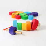 Grimms bright and chunky handcrafted wooden with threading needle and string through the holes