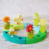 A beautiful Spring inspired  display using a Grimm's Waldorf Celebration Ring and various decorative figures available at Babipur.
