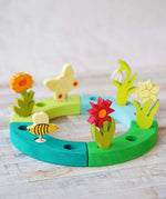 A beautiful Spring inspired  display using a Grimm's Waldorf Celebration Ring and various decorative figures available at Babipur.