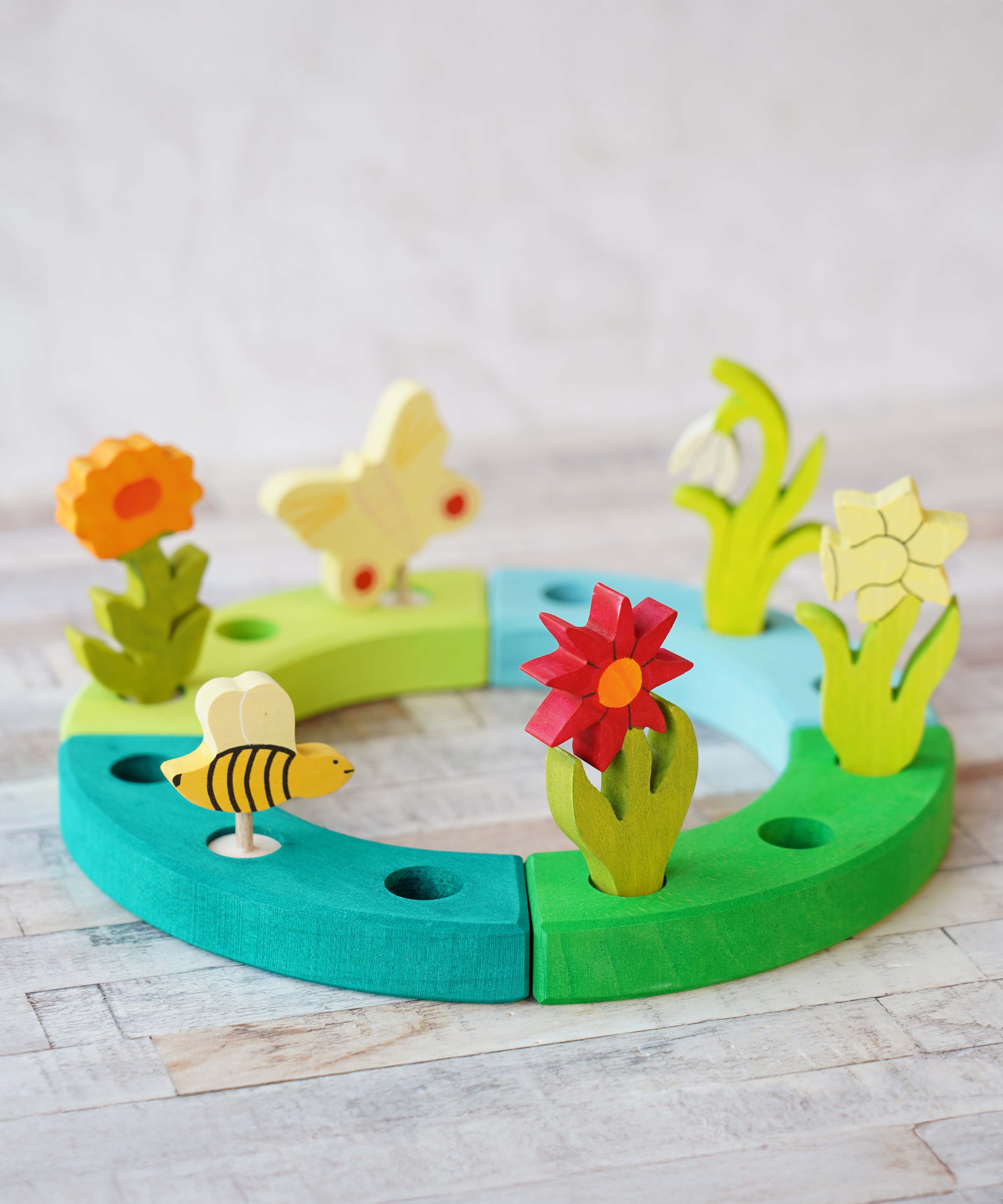 A beautiful Spring inspired  display using a Grimm's Waldorf Celebration Ring and various decorative figures available at Babipur.