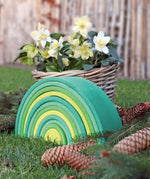 A autumnal display using the Grimms forest large wooden rainbow 12 piece set available at Babipur with various woodland pieces.