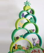 A decorative stack made from the Grimms forest large wooden rainbow 12 piece set and various decorative figures all available at Babipur.