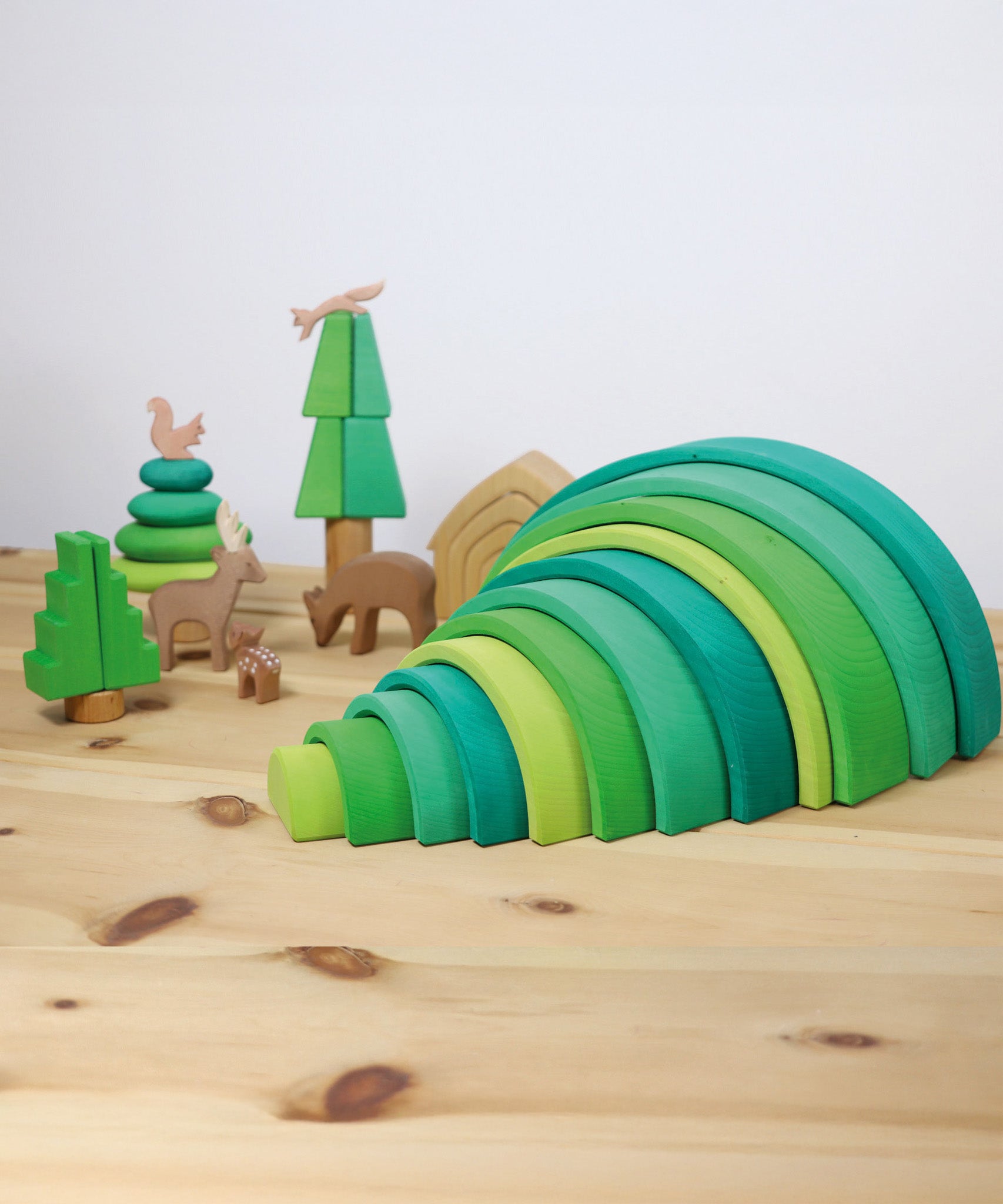 A cute little display using the Grimms forest large green wooden rainbow and various Ostheimer woodland animal figures, all available at Babipur.