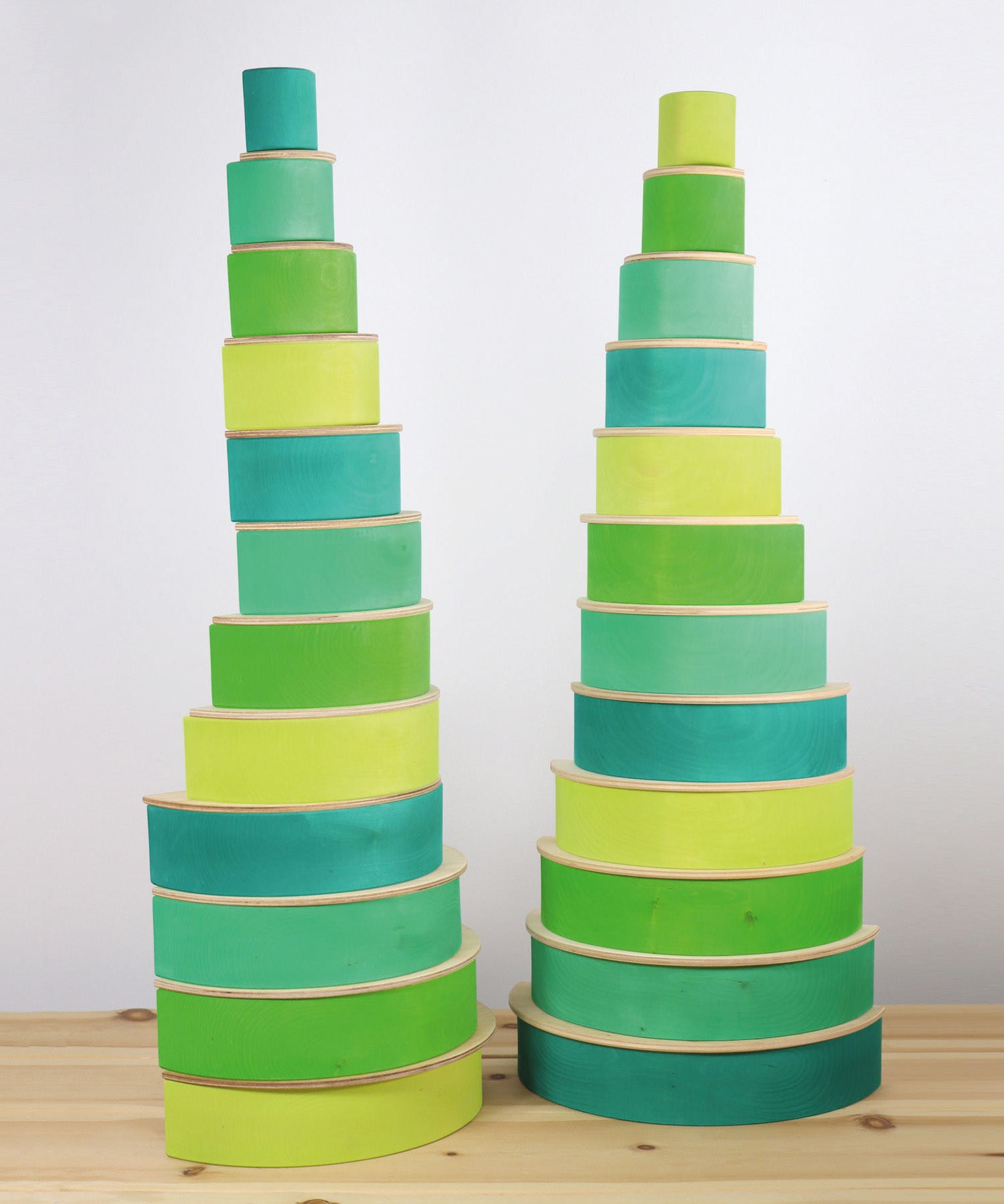 2 tall shelf stacks made from the forest and meadow Grimms wooden rainbow sets with natural semi circles. These sets are available at Babipur.