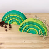 A simple display showing the forest and meadow Grimms green wooden 12 piece rainbow sets. These two are available at Babipur.
