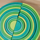 A close up of the Grimms forest and meadow wooden rainbow sets showing the different shades of green for each rainbow. These two are available at Babipur.