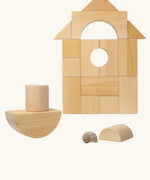 Grimm's giant natural wooden building blocks set used to create a boat shape with the other blocks stacked in the background.