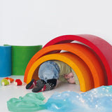 Child crawling underneath a Grimm's Giant Rainbow.
