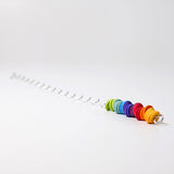 A giant Grimms spirelli available at Babipur. This  winding metal wire comes with coloured wooden disks that make a noise when tipped over. 