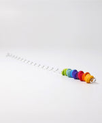 A giant Grimms spirelli available at Babipur. This  winding metal wire comes with coloured wooden disks that make a noise when tipped over. 