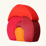 Back of Grimm's gnome house wooden stacking toy. 4 piece red and orange wooden block puzzle.