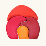 Back of Grimm's gnome house wooden stacking toy. 4 piece red and orange wooden block puzzle.
