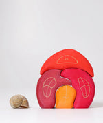 Grimm's gnome house wooden stacking toy. 4 piece red and orange wooden block puzzle.