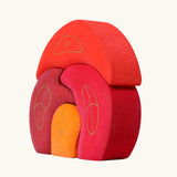 Side of Grimm's gnome house wooden stacking toy. 4 piece red and orange wooden block puzzle.