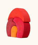 Side of Grimm's gnome house wooden stacking toy. 4 piece red and orange wooden block puzzle.