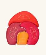 Grimm's gnome house wooden stacking toy. 4 piece red and orange wooden block puzzle.