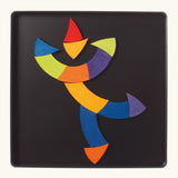 A dancing clown made from the Grimm's bright wooden Goethe magnetic pieces displayed in a tin 
